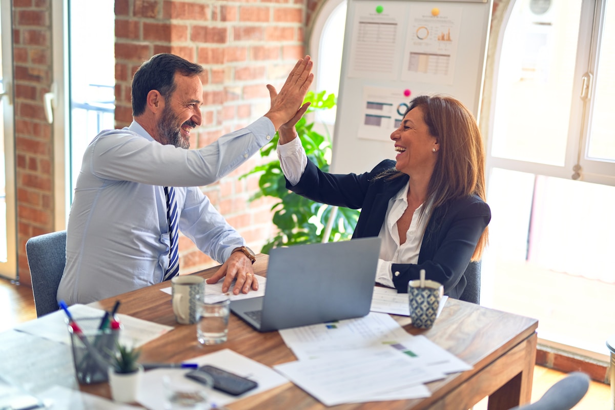 Two colleagues reviewing a client programme